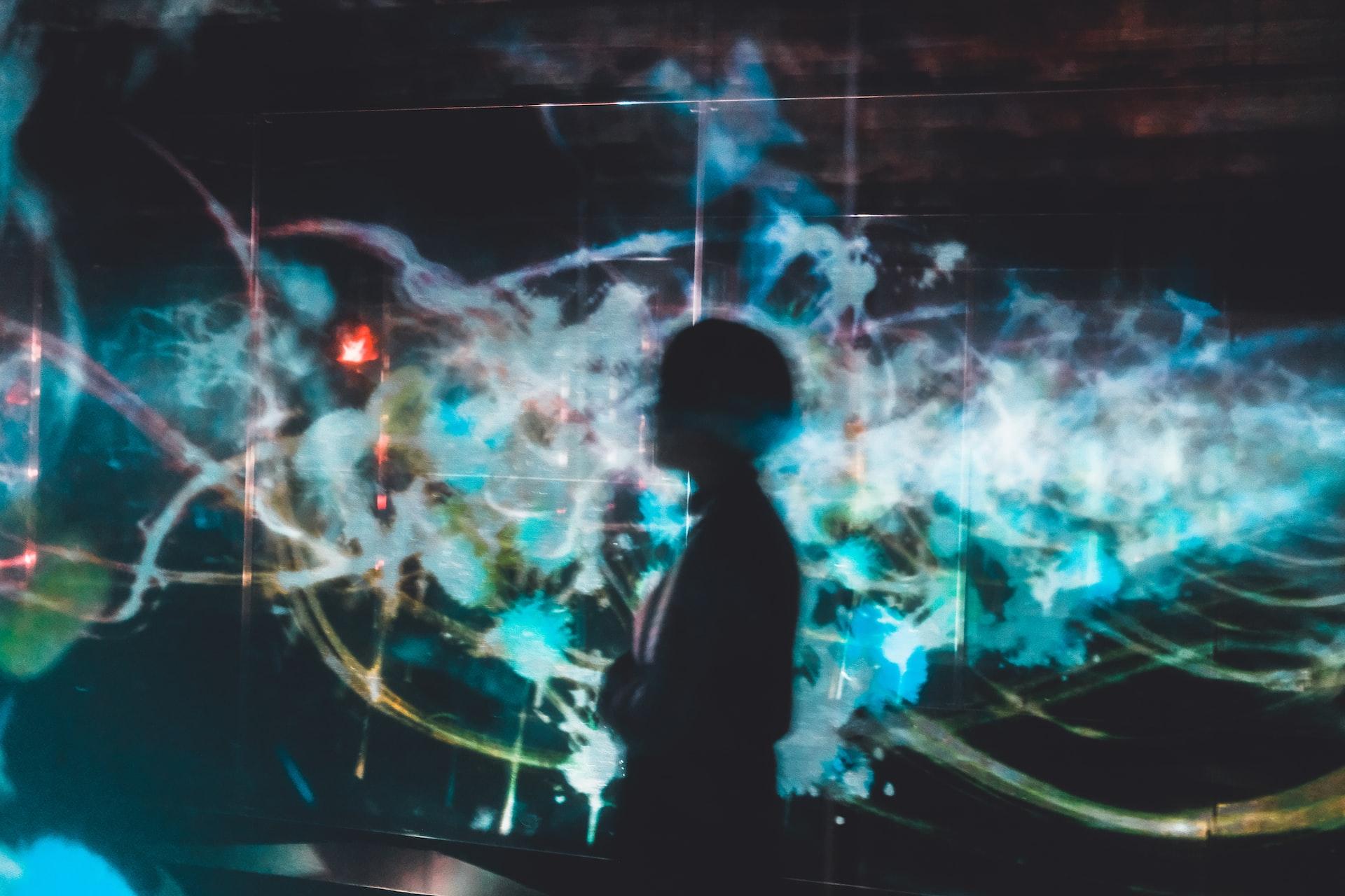 Silhouette of a person against a blue digital backdrop
